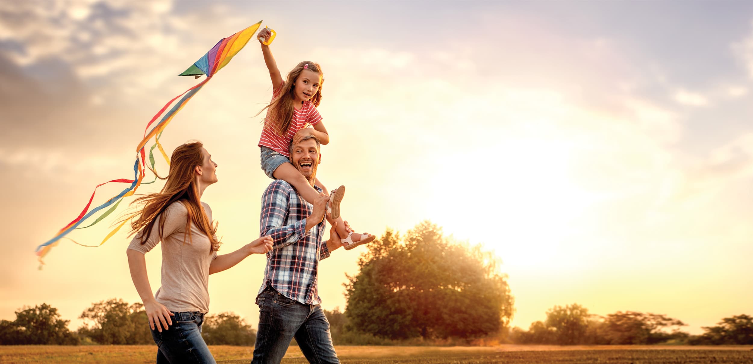 Family of three walking in a park